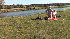 Wild beach. Nudist beach. Outdoors on bank of river lover fucks doggystyle beautiful sexy MILF Frina Thumb