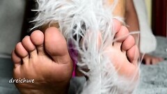 Close-up foot fetish with feather Thumb