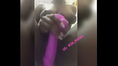 Jamaican mask model plays with toy Thumb